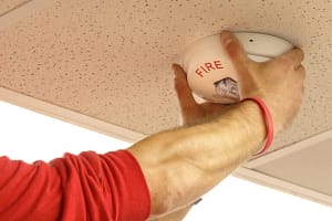 Fire tech installing horn strobe